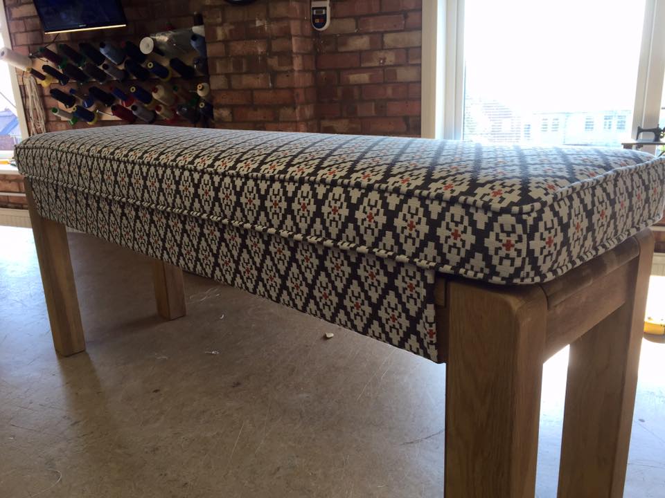 Wood bench with blue diamond patterned textile