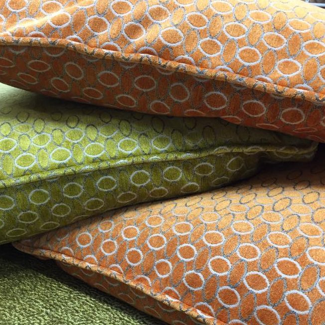 Orange and green pillow with circle patterns