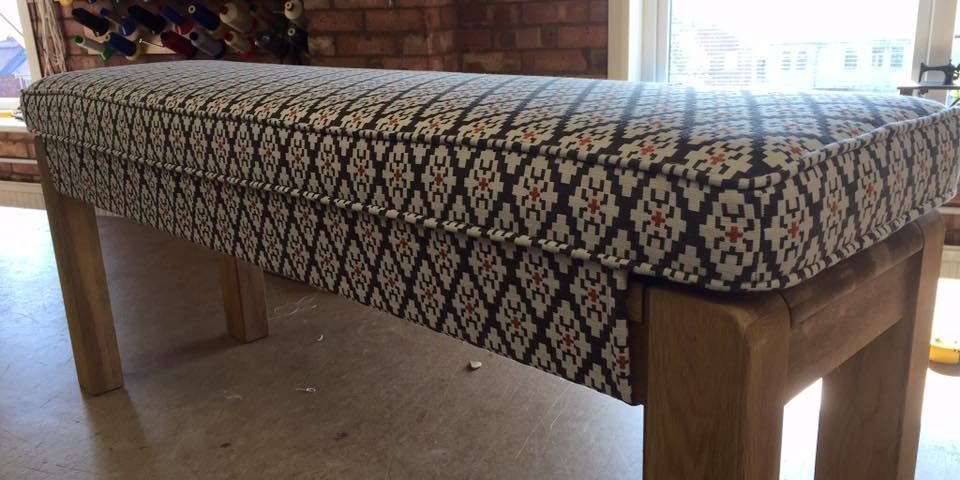 Wood bench with blue diamond patterned textile