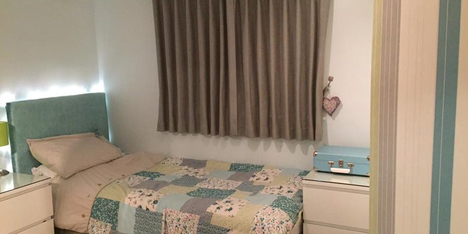 Grey curtains and patchwork quilt