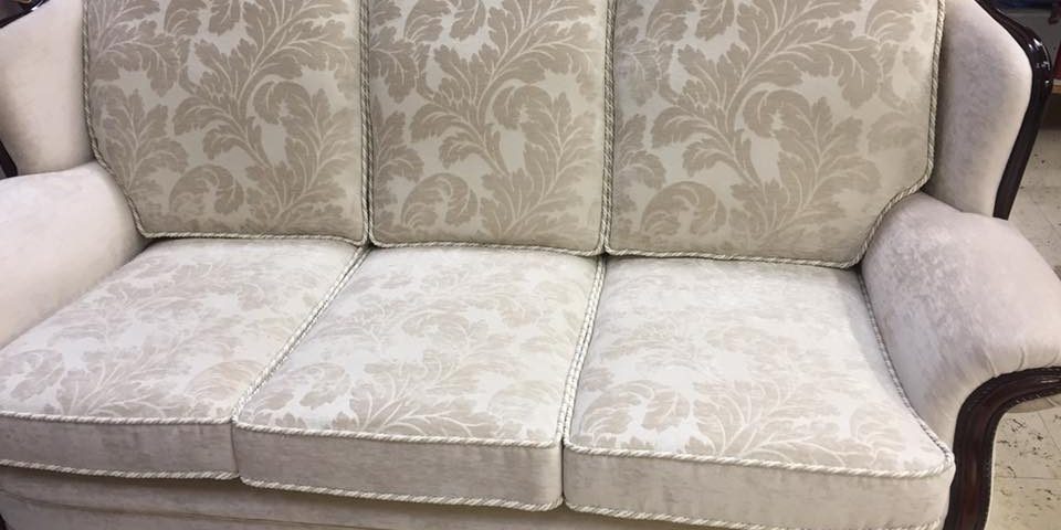 eggshell coloured suede sofa with flower patterned cushions