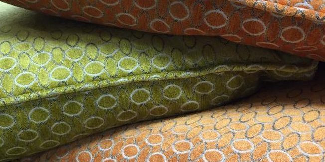 Orange and green pillow with circle patterns