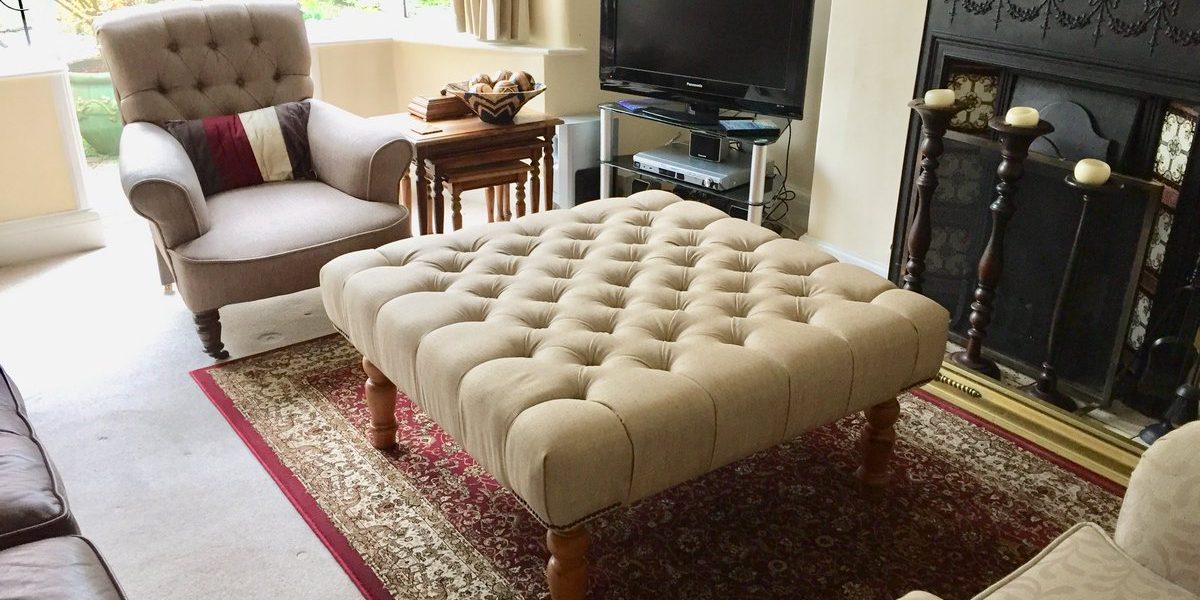 Big footstool on a large cream and red carpet